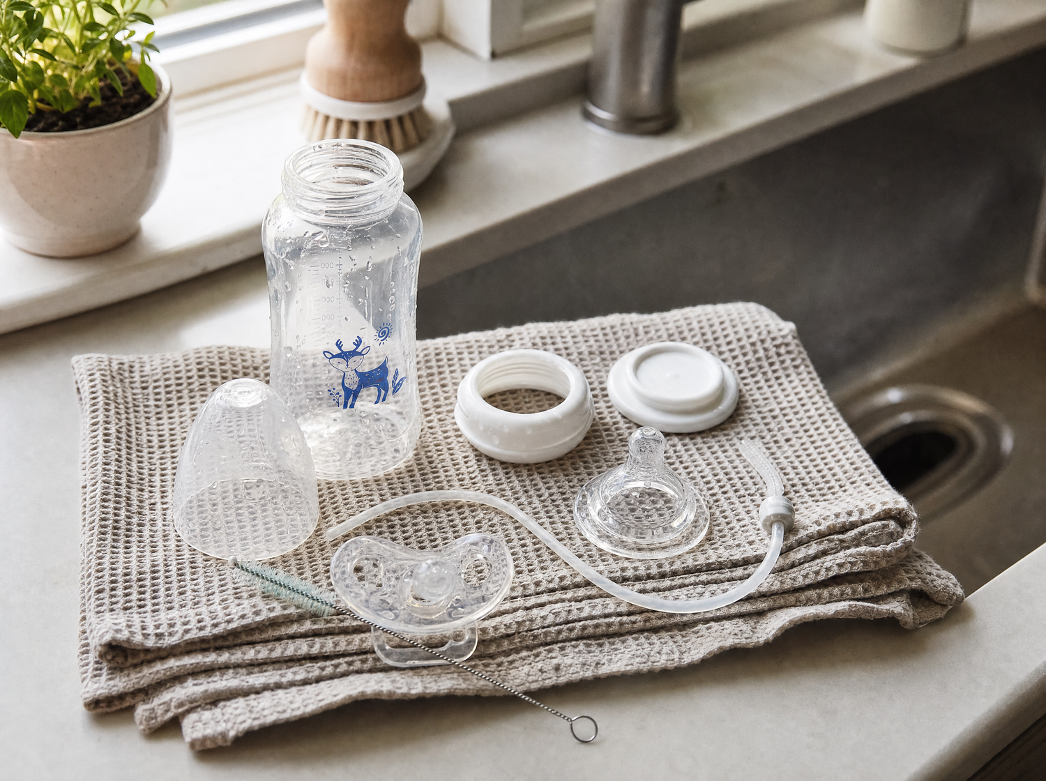 EasySip bottle taken apart to dry beside a kitchen sink