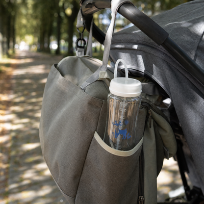 EasySip bottle tucked into a changing bag hanging from a pram handle