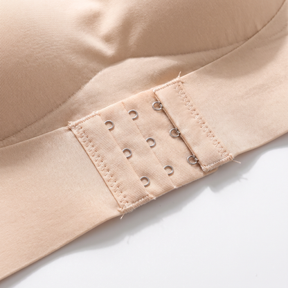 Close-up of the three-row hook-and-eye fastening band at the centre front