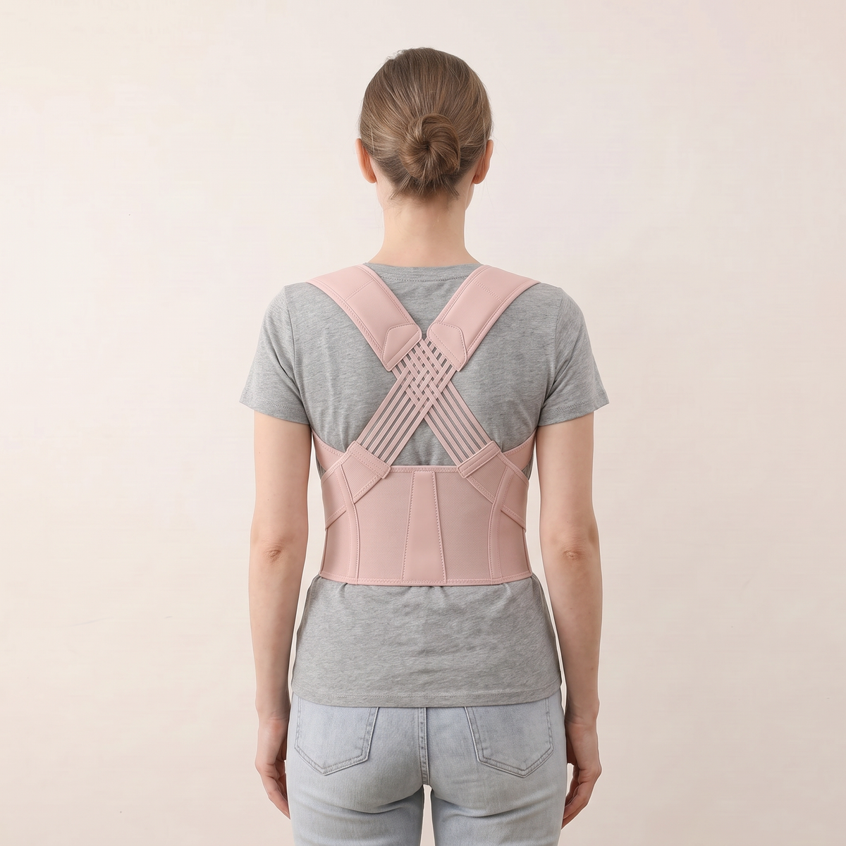 Back view of the PostureOn brace in blush pink, crossed panel across the upper back