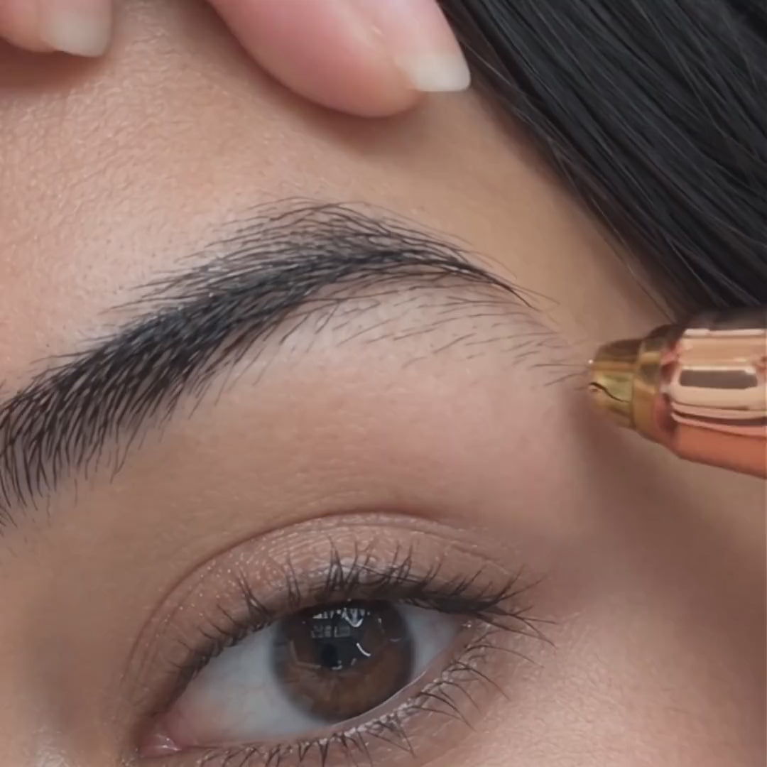 Close-up of the PeachPen brow head trimming along an eyebrow